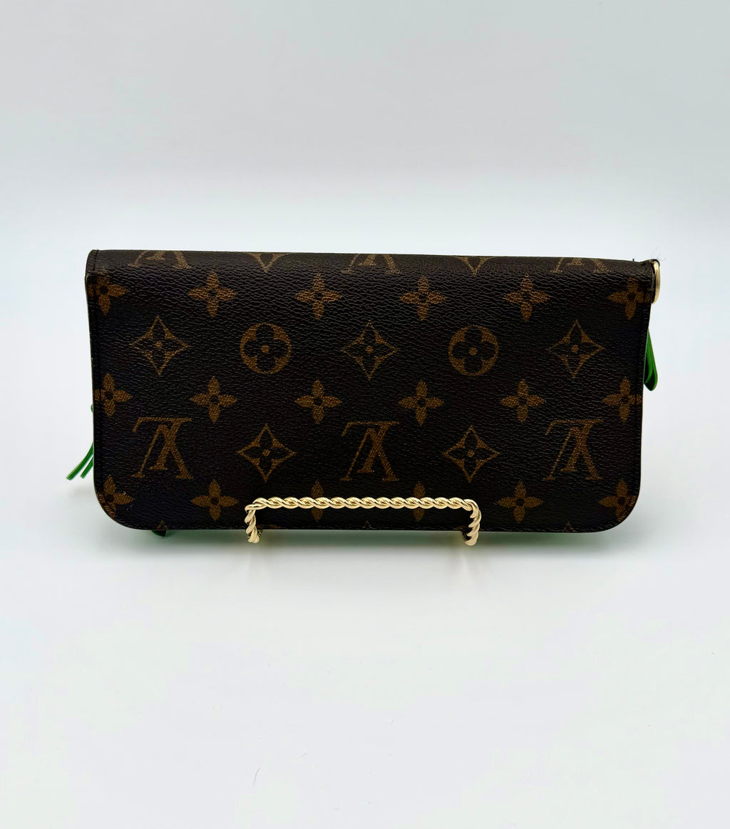 Designer wallet with monogram pattern on a white background
