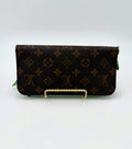Designer wallet with monogram pattern on a white background