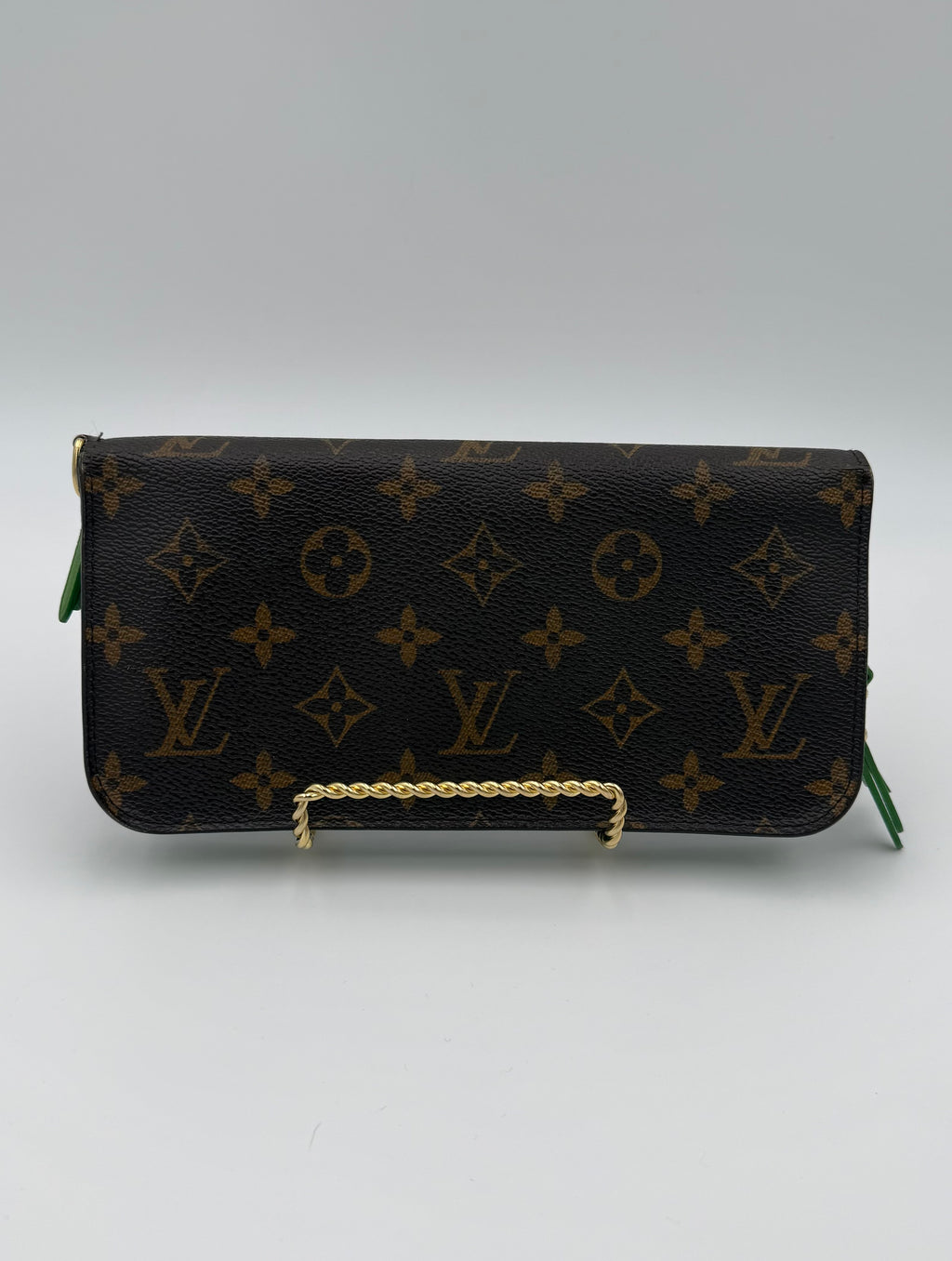 Designer handbag with monogram pattern on a white background