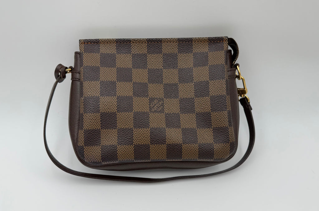 Brown checkered handbag on a light gray background