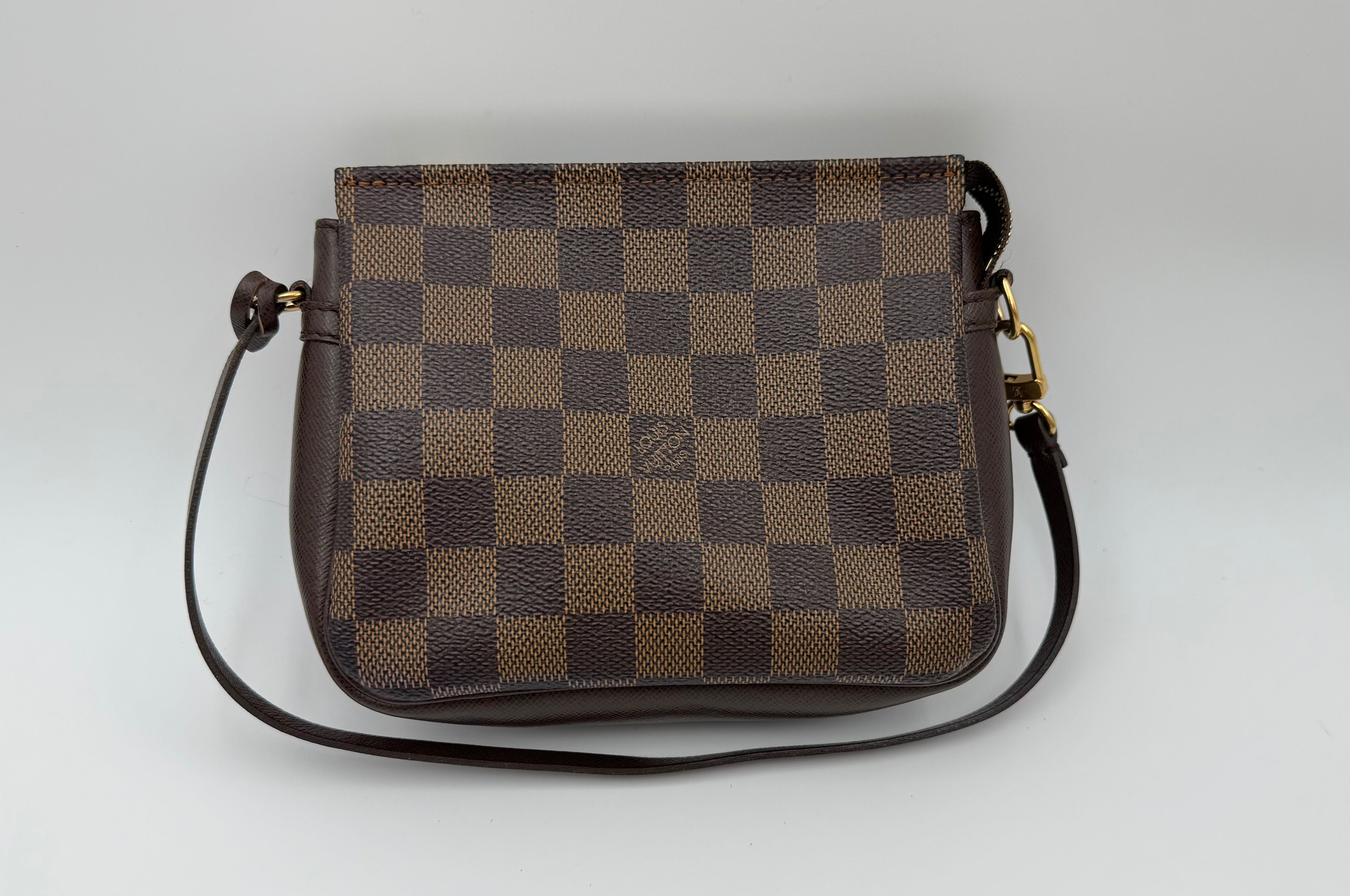 Brown checkered handbag on a light gray background
