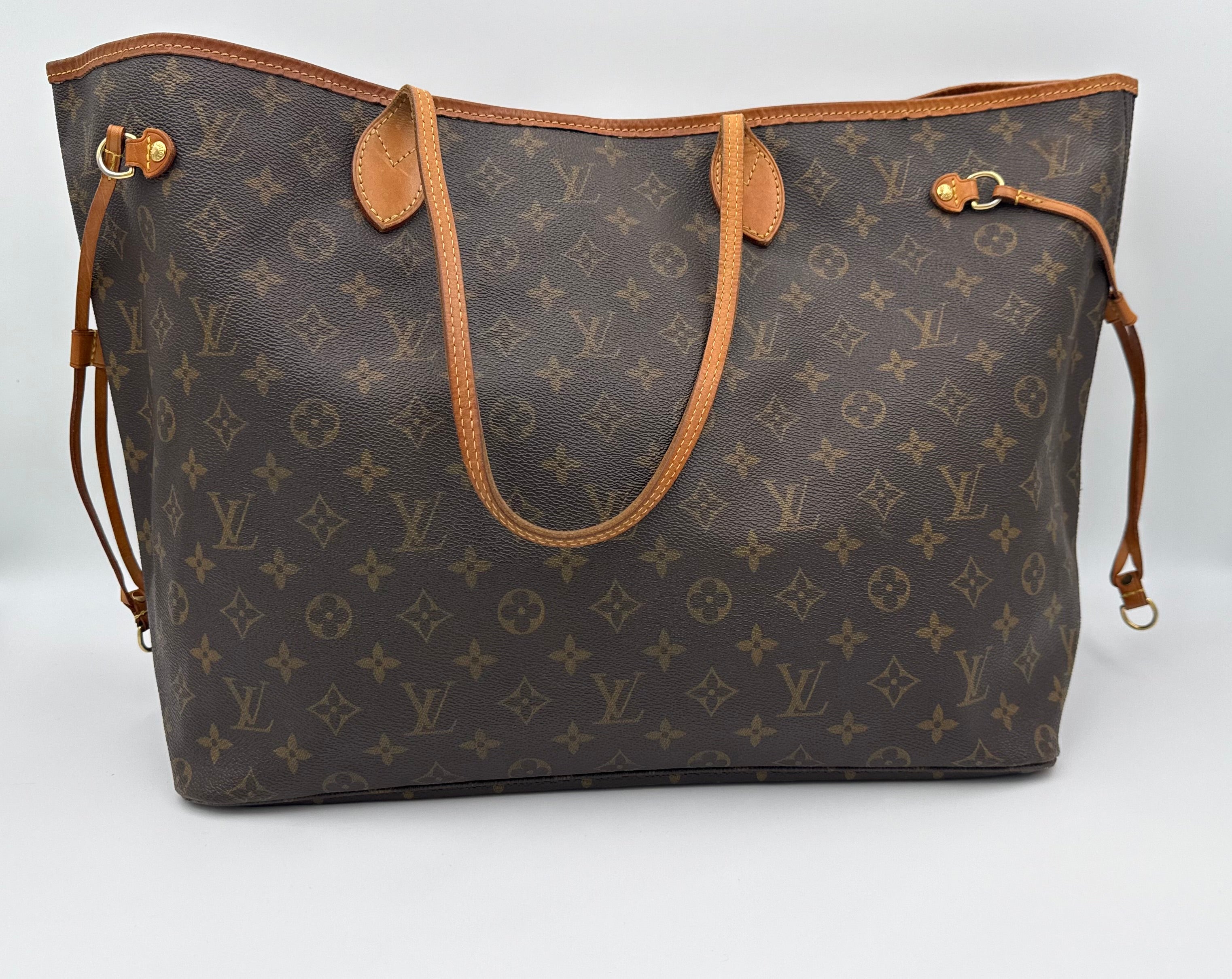 Designer handbag with monogram pattern on a white background