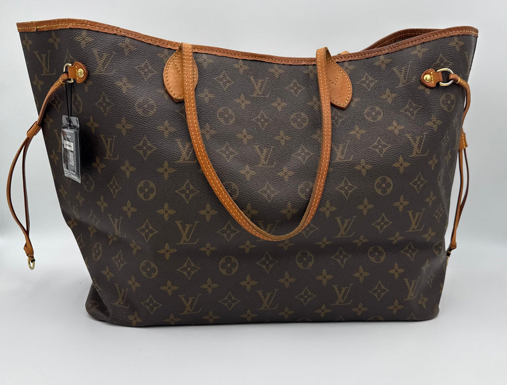 Designer handbag with monogram pattern on a white background