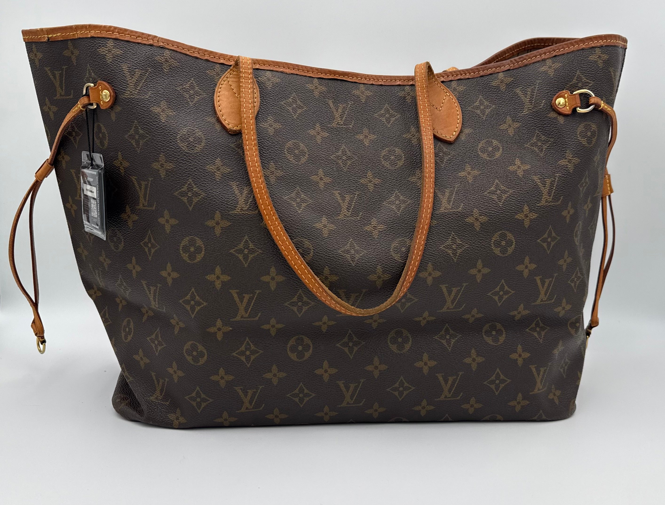 Designer handbag with monogram pattern on a white background