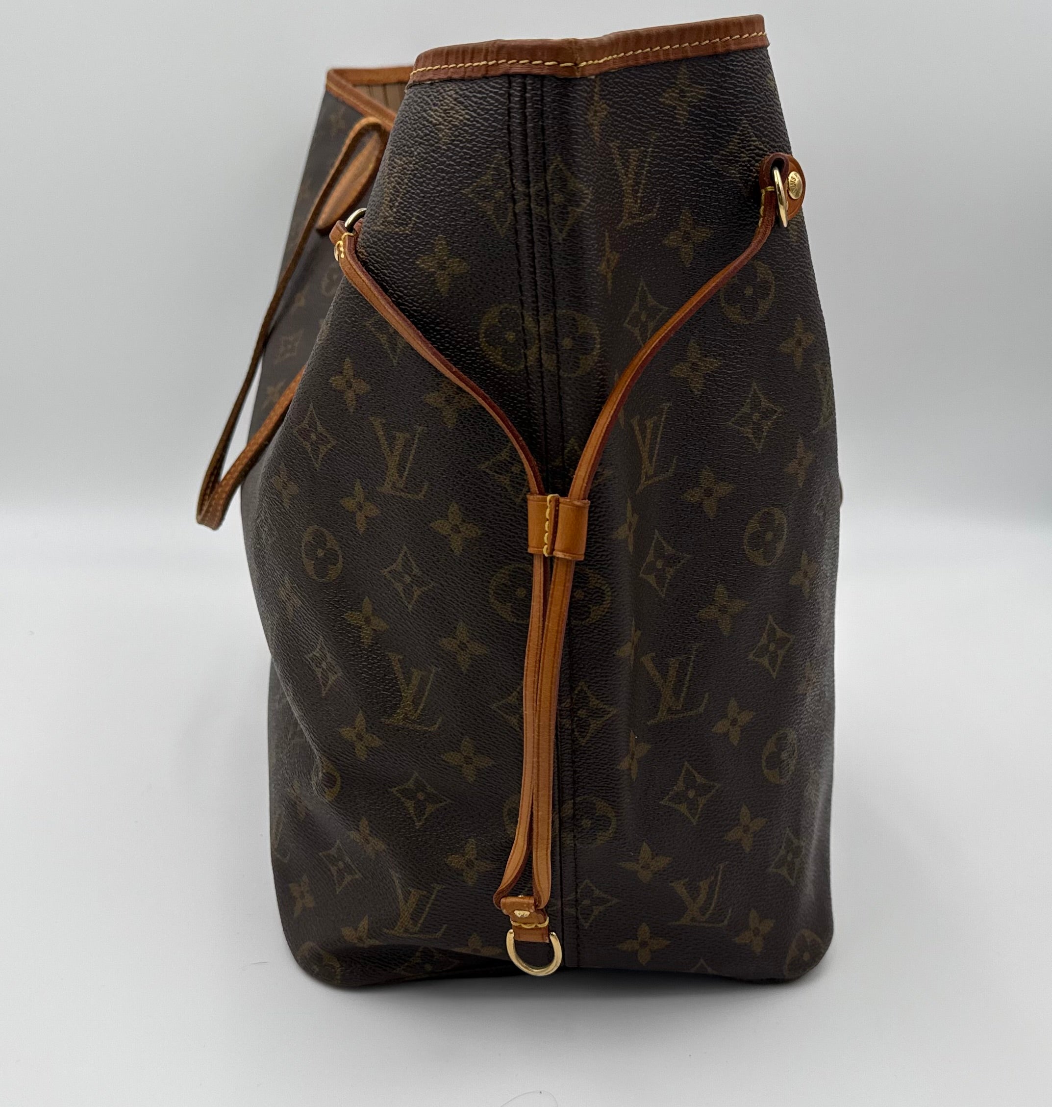 Brown leather bag with monogram pattern on a white background
