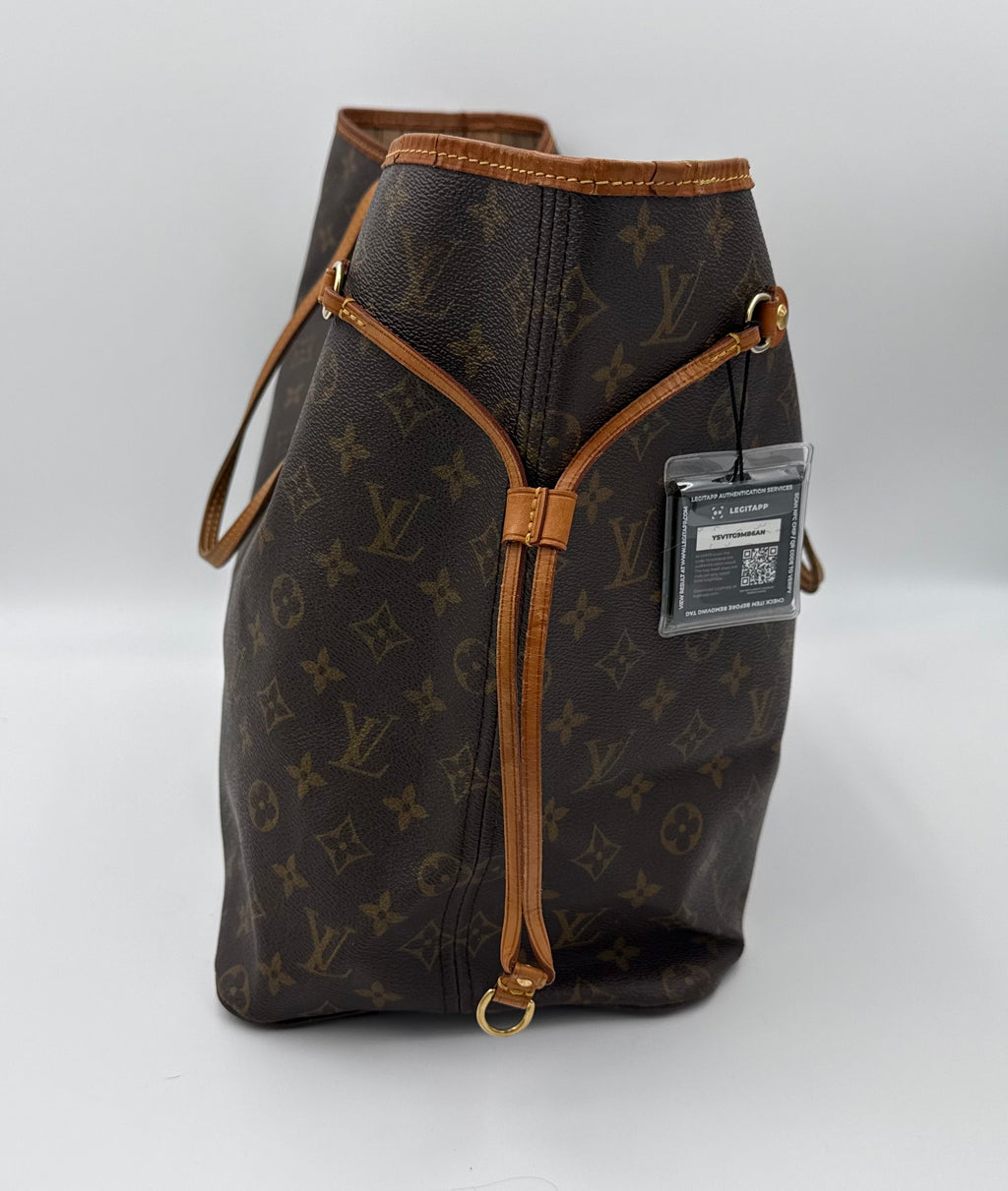 Designer handbag with monogram pattern and brown accents on a white background