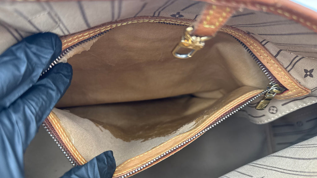 Open interior pocket with visible wear 