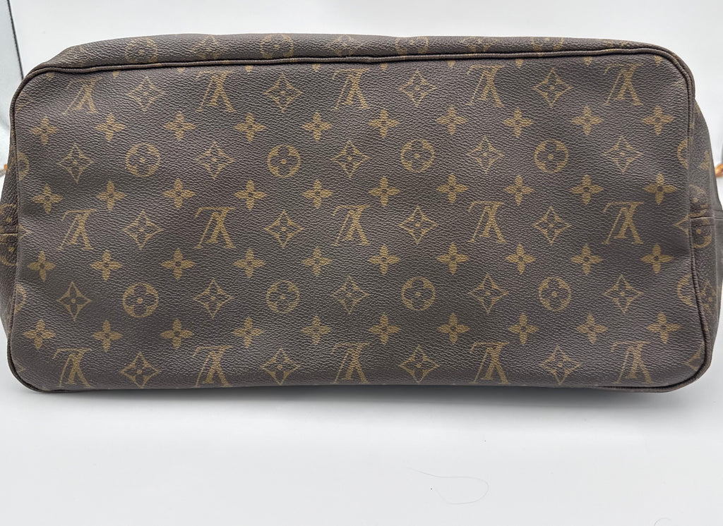 Brown leather bag with gold monogram pattern on a white background
