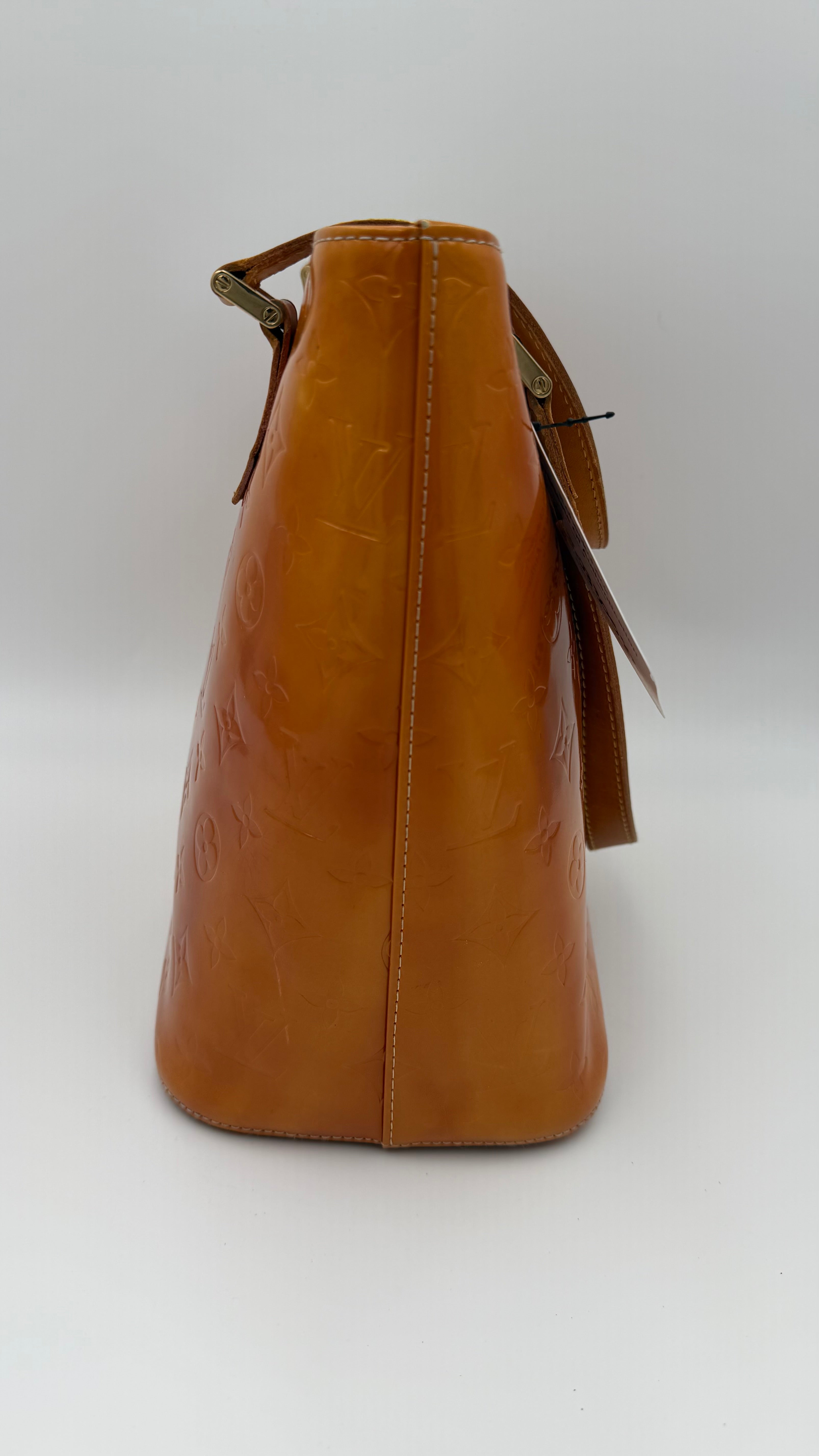Louis Vuitton Vernis Houston tote in amber caramel patent leather with embossed monogram and shoulder straps on white background