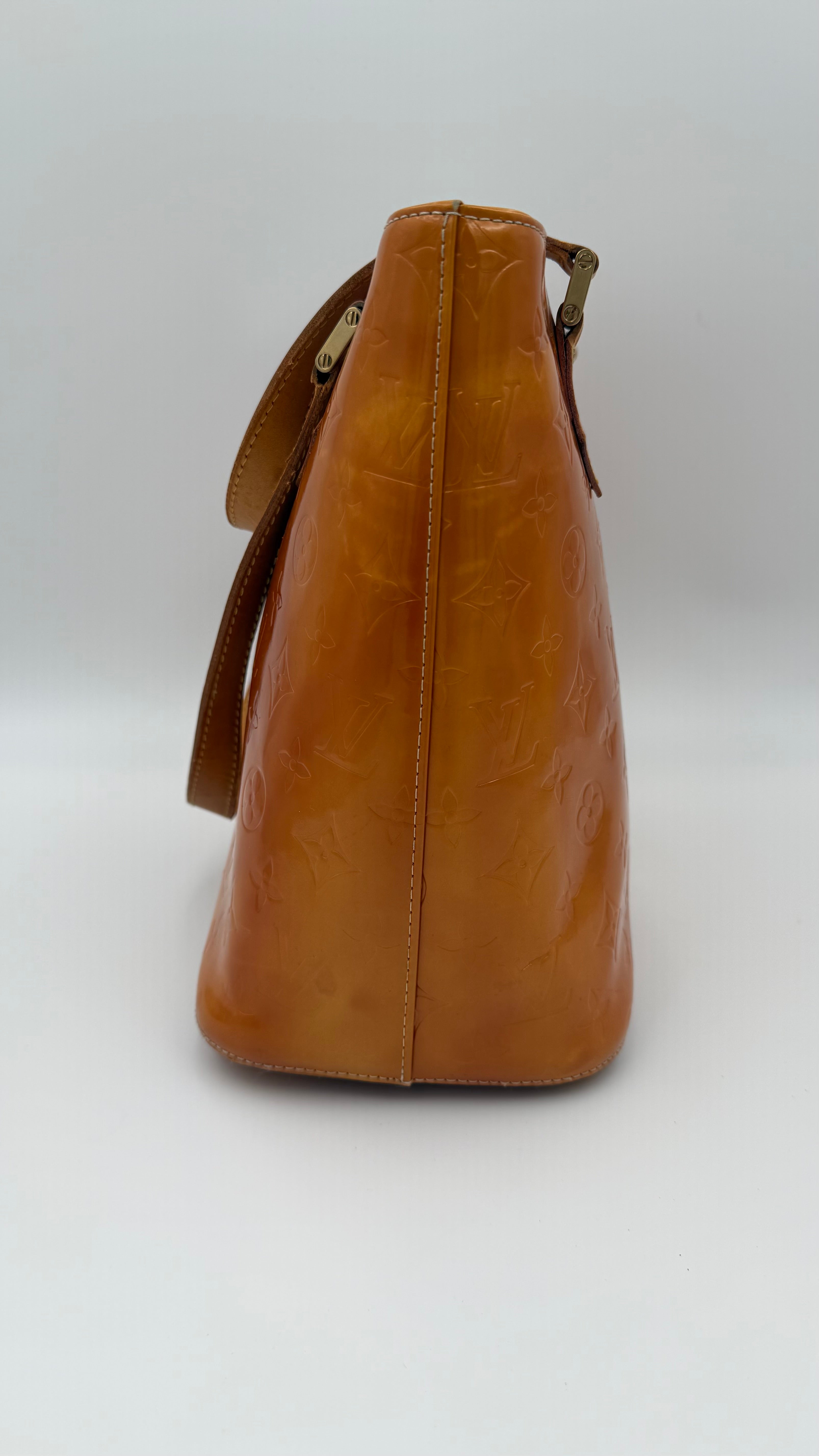 Louis Vuitton Vernis Houston tote in amber caramel patent leather with embossed monogram and shoulder straps on white background