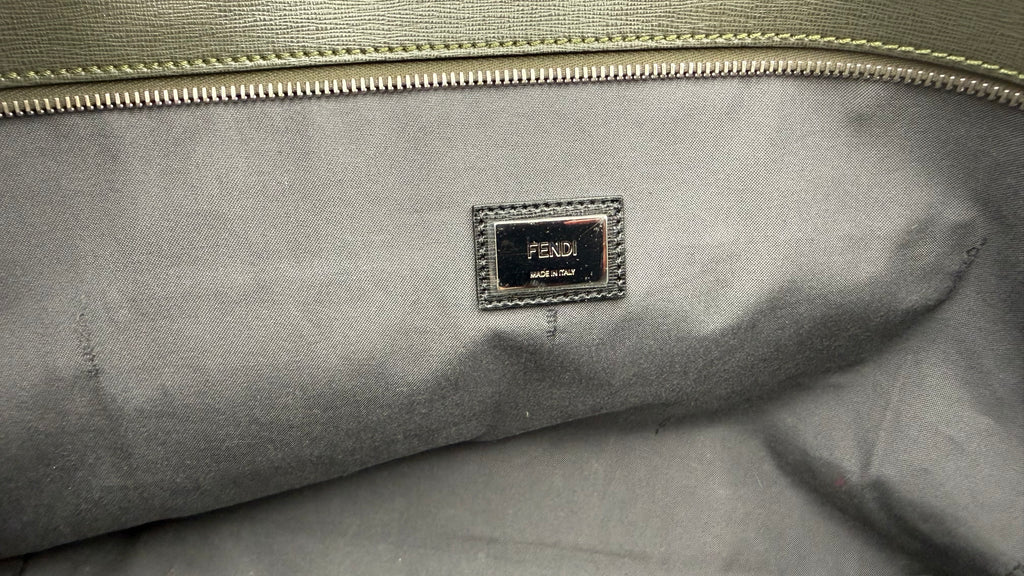 Close-up of a Fendi logo on a black fabric surface