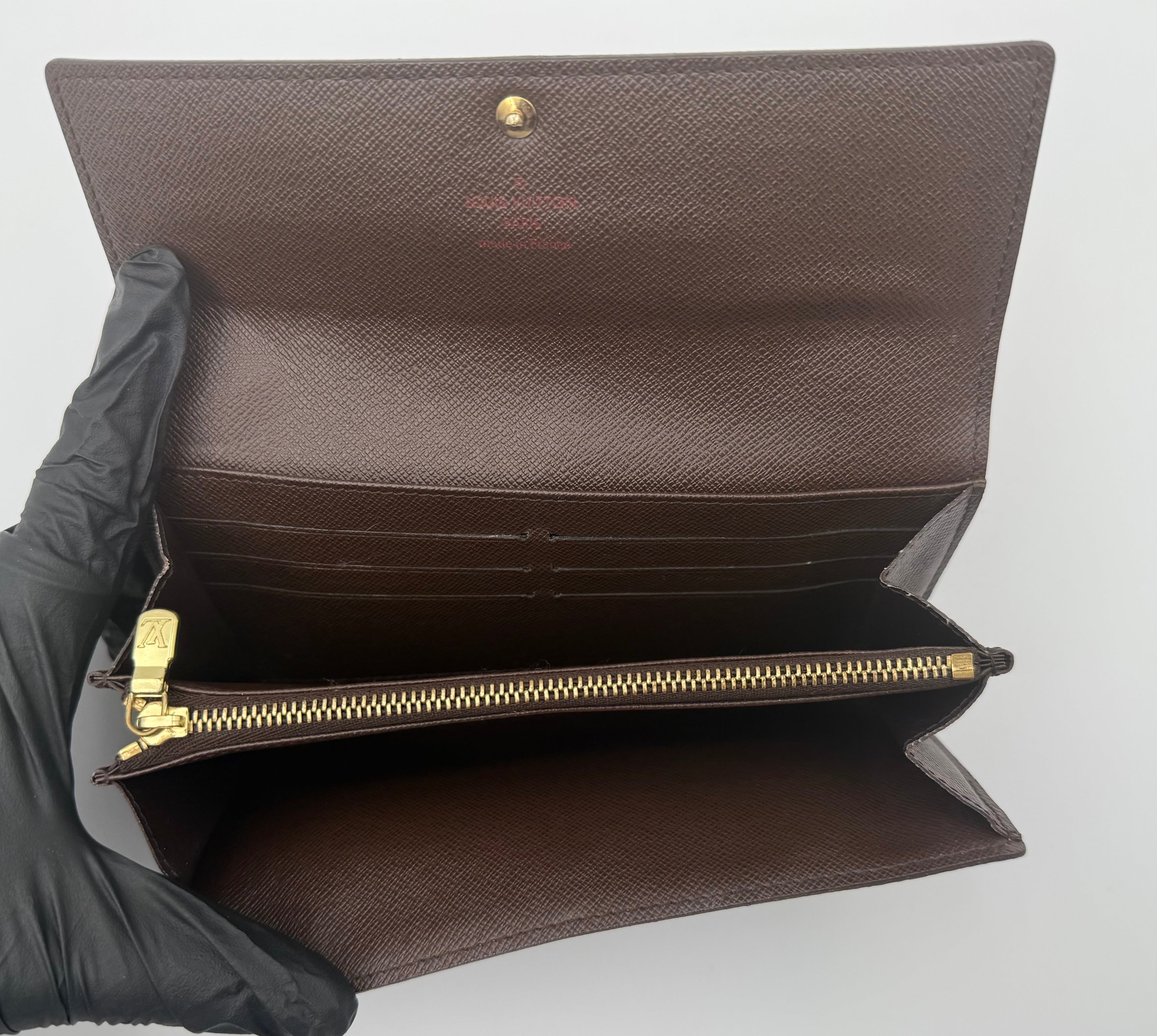Louis Vuitton wallet interior showing card slots and zipper compartment, clean and functional”