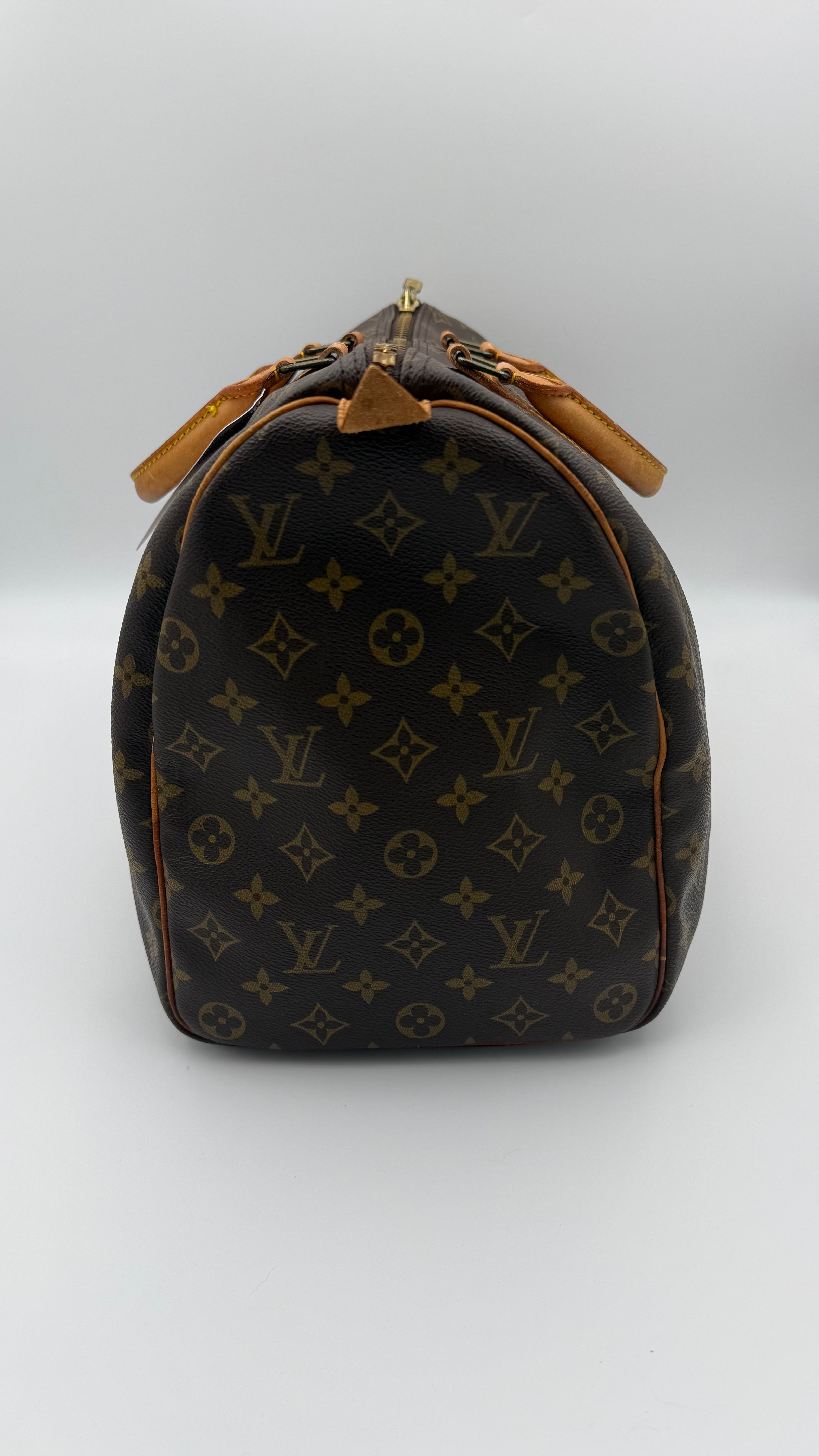 Louis Vuitton monogram duffel bag on a white background