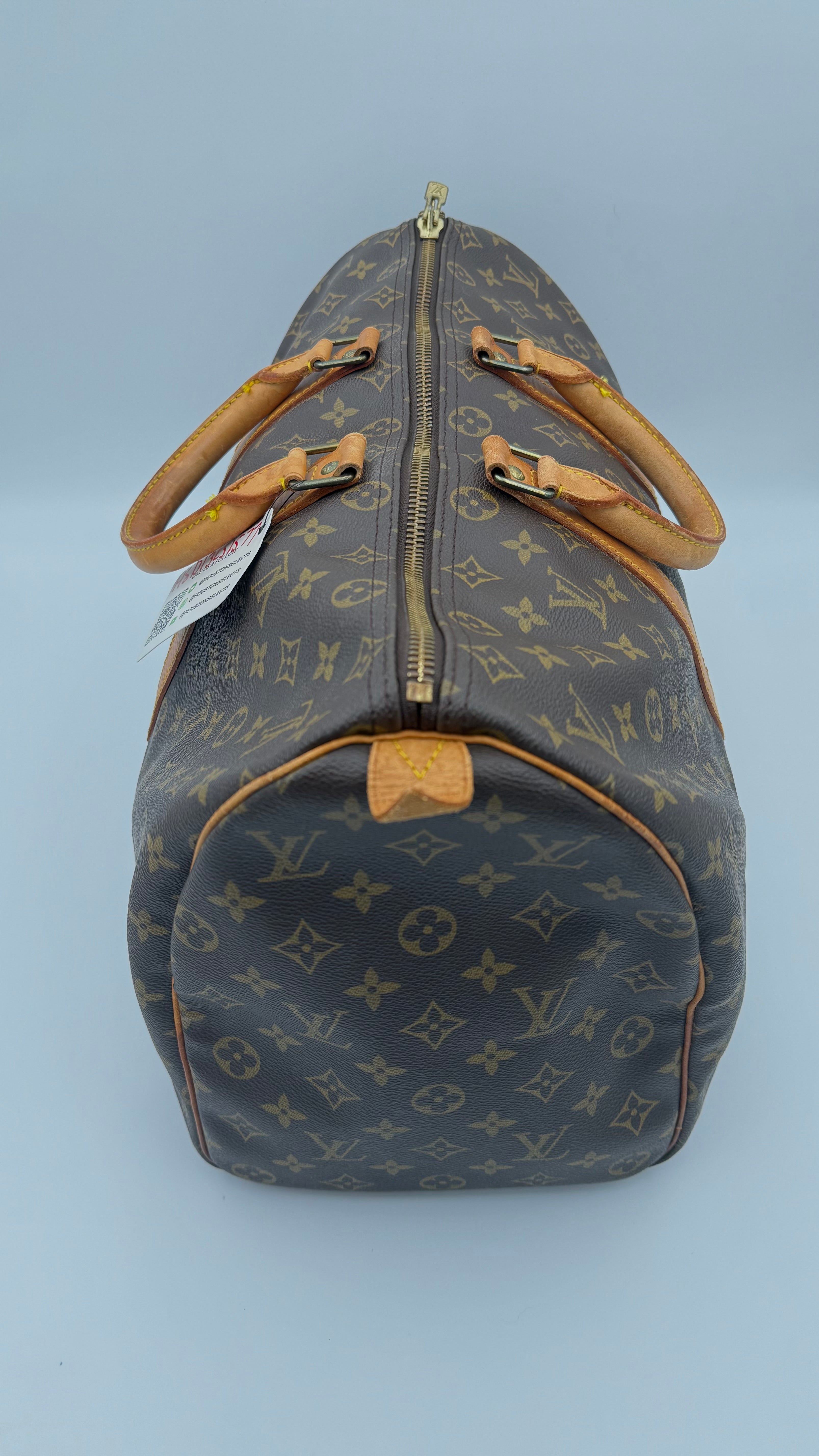Louis Vuitton monogram duffel bag on a white background