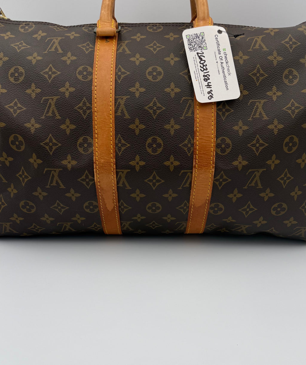 Brown patterned bag with a visible QR code label on a white background