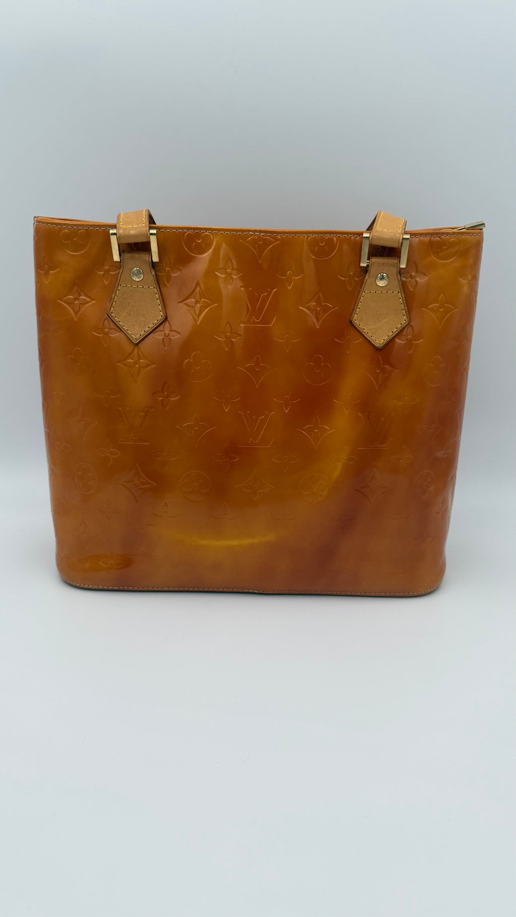 Louis Vuitton Vernis Houston tote in amber caramel patent leather with embossed monogram and shoulder straps on white background